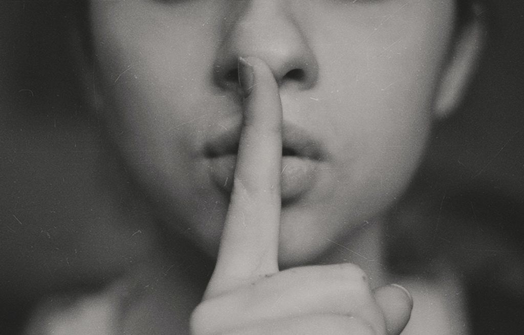 Woman with a finger on her lips 